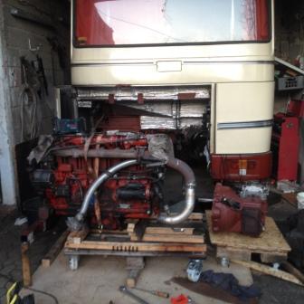 Motor und Getriebe auf rollbrettern hinter dem Bus